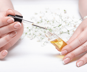 woman applying cuticle cleaner