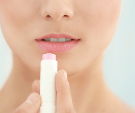 woman using lip balm